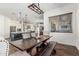Open-concept dining room with rustic wood table, bench seating, and views into the modern kitchen at 22414 W Meade Ln, Buckeye, AZ 85326
