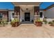Inviting home entrance, featuring stone pillars and decorative planters, adding charm and curb appeal at 22414 W Meade Ln, Buckeye, AZ 85326