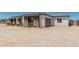Single-story home with a large unpaved front yard, complemented by wood fencing, enhancing its curb appeal at 22414 W Meade Ln, Buckeye, AZ 85326