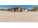 Single-story home with a large unpaved front yard, complemented by wood fencing, enhancing its curb appeal at 22414 W Meade Ln, Buckeye, AZ 85326