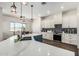 Modern kitchen featuring stainless steel appliances, white cabinetry, and a stylish blue island at 22414 W Meade Ln, Buckeye, AZ 85326