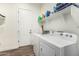 Functional laundry room with washer, dryer, and storage shelf at 22414 W Meade Ln, Buckeye, AZ 85326