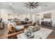 Open-concept living room and kitchen area with a large comfortable couch and adjacent modern kitchen at 22414 W Meade Ln, Buckeye, AZ 85326