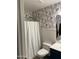 Bathroom featuring wallpaper and shower with a striped curtain at 2723 E Rockledge Rd, Phoenix, AZ 85048