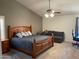 Spacious bedroom with a ceiling fan and a comfortable seating area at 2723 E Rockledge Rd, Phoenix, AZ 85048
