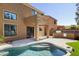 Spacious backyard with sparkling pool, BBQ, artificial turf, and outdoor dining area at 3025 E Fremont Rd, Phoenix, AZ 85042