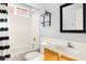 Bathroom with tub-shower, single sink vanity and stylish decor at 3025 E Fremont Rd, Phoenix, AZ 85042