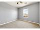 Carpeted bedroom featuring a ceiling fan and a single window allowing natural light at 3025 E Fremont Rd, Phoenix, AZ 85042