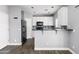 Modern kitchen with white cabinets, black appliances and eat-in bar area at 3025 E Fremont Rd, Phoenix, AZ 85042