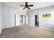 Large primary bedroom with ceiling fan and doorway to adjoining bathroom at 3025 E Fremont Rd, Phoenix, AZ 85042