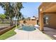 Inviting backyard pool features lush landscaping, rock waterfall, and artificial grass at 3025 E Fremont Rd, Phoenix, AZ 85042