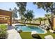 Sparkling backyard pool features rock waterfall, manicured landscaping, and mature trees at 3025 E Fremont Rd, Phoenix, AZ 85042