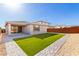A beautiful backyard featuring artificial grass, modern landscaping, and a covered patio area at 32611 N 20Th Dr, Phoenix, AZ 85085