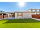 This home has a grassy backyard, and a covered patio with an outdoor lounge at 32611 N 20Th Dr, Phoenix, AZ 85085