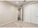 This bedroom has neutral walls and carpet, with a closet and a door to another room at 32611 N 20Th Dr, Phoenix, AZ 85085