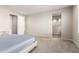 Bedroom featuring plush carpeting, a queen bed, and an attached bathroom at 32611 N 20Th Dr, Phoenix, AZ 85085