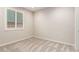 This bedroom has neutral walls and carpet, with a bright window with white shutters at 32611 N 20Th Dr, Phoenix, AZ 85085