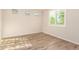 This bedroom has plank floors, white walls, and a bright window with white shutters at 32611 N 20Th Dr, Phoenix, AZ 85085
