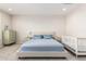Bright bedroom featuring neutral colors, a queen size bed, and a white crib at 32611 N 20Th Dr, Phoenix, AZ 85085