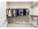 Walk-in closet with an organized hanging rod, shelving, and carpet flooring at 32611 N 20Th Dr, Phoenix, AZ 85085
