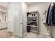 Organized walk-in closet with ample shelving and space for storage and clothing at 32611 N 20Th Dr, Phoenix, AZ 85085