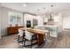 Open-concept dining area with modern lighting, stylish furniture, and seamless flow into the kitchen space at 32611 N 20Th Dr, Phoenix, AZ 85085