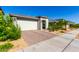 Street view of a modern home with a well-manicured lawn featuring a two-car garage and neutral color palette at 32611 N 20Th Dr, Phoenix, AZ 85085