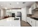Bright kitchen featuring white cabinets, stainless steel appliances, a kitchen island and pendant lighting at 32611 N 20Th Dr, Phoenix, AZ 85085