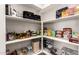 Walk-in pantry with lots of shelving, storage containers and food items neatly organized at 32611 N 20Th Dr, Phoenix, AZ 85085