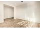 This is a spacious room with light colored plank floors and light neutral walls at 32611 N 20Th Dr, Phoenix, AZ 85085