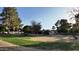 A serene backyard with a mix of lush greenery and mature trees at 3323 N 103Rd Ave, Avondale, AZ 85392