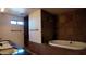 Bathroom with bathtub, decorative tile, and vanity with dual sinks at 3323 N 103Rd Ave, Avondale, AZ 85392