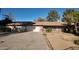 Single-story home featuring a two-car garage, desert landscaping, and a concrete driveway at 3323 N 103Rd Ave, Avondale, AZ 85392
