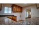 Kitchen area featuring wood cabinets, granite counters, and an open layout at 3323 N 103Rd Ave, Avondale, AZ 85392