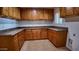 Efficient kitchen with light wood cabinets, granite countertops, and tiled flooring at 3323 N 103Rd Ave, Avondale, AZ 85392