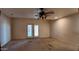 Living room area featuring double doors to backyard and ceiling fan at 3323 N 103Rd Ave, Avondale, AZ 85392