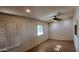Living room featuring plantation shutters, ceiling fans, and tile floors at 3323 N 103Rd Ave, Avondale, AZ 85392