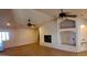 Spacious living room featuring a fireplace, ceiling fans, and tile floors at 3323 N 103Rd Ave, Avondale, AZ 85392