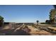 Expansive lot featuring mature trees, a storage container and partial fencing at 3323 N 103Rd Ave, Avondale, AZ 85392