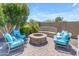 Backyard featuring comfortable seating around a stone fire pit and desert landscaping at 35701 N Bandolier Dr, San Tan Valley, AZ 85144