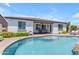 Stunning backyard with a refreshing pool, covered patio and lush landscaping, perfect for entertaining at 35701 N Bandolier Dr, San Tan Valley, AZ 85144
