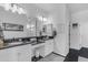Elegant bathroom with dual sinks, a vanity area, and sleek black and white accents for a modern look at 35701 N Bandolier Dr, San Tan Valley, AZ 85144