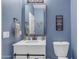 Bathroom with modern vanity, attractive decor, and blue accent wall at 35701 N Bandolier Dr, San Tan Valley, AZ 85144
