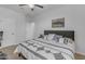 Bedroom with neutral walls, ceiling fan, and large bed with decorative pillows at 35701 N Bandolier Dr, San Tan Valley, AZ 85144