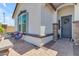 Welcoming front porch with stone accents and comfortable outdoor seating at 35701 N Bandolier Dr, San Tan Valley, AZ 85144