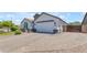 Lovely single-story home displaying a stone facade, attached two-car garage and brick paver driveway at 35701 N Bandolier Dr, San Tan Valley, AZ 85144
