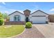 Charming single-story home featuring a well-manicured lawn, stone accents, and a welcoming two-car garage at 35701 N Bandolier Dr, San Tan Valley, AZ 85144