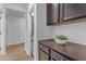Hallway featuring dark wood cabinets and hard surface flooring at 35701 N Bandolier Dr, San Tan Valley, AZ 85144