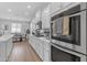 Well-equipped kitchen featuring stainless steel appliances, white cabinets, and quartz countertops at 35701 N Bandolier Dr, San Tan Valley, AZ 85144