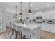 Inviting kitchen featuring an island with counter seating and elegant pendant lights at 35701 N Bandolier Dr, San Tan Valley, AZ 85144